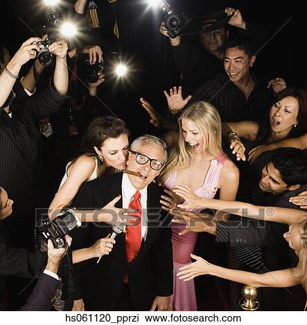 Stock Photo of Young women fawning over old male celebrity ...