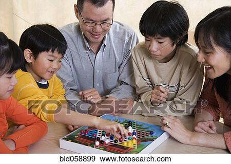 Asian Family Playing Board Game Asian Family Playing Board Game
