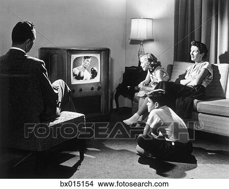 Living Room 1950s stock photo of 1950s couple in darkened living room watching tv Living Room 1950s stock photo of 1950s couple in darkened living room watching tv