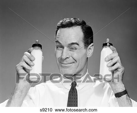 1960S Man In Shirt And Tie Winking At Camera Holding Two Baby Milk Bottles - s9210