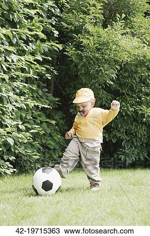 kicking toddler ball soccer fotosearch