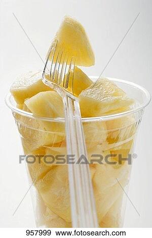 Stock Photograph of Pineapple chunks in a plastic beaker ...