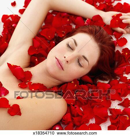 Stock Photo of Woman covered with petals of roses k1100763 