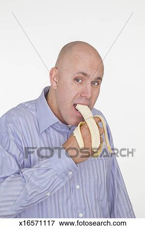 middle-age-bald-man-eating-a-banana-picture__x16571117.jpg