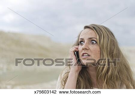 Stock Photo - Portrait of a Danish woman, 28 years old, on cell phone with crazed expression. Fotosearch - Search Stock Photography, Print Pictures, Images, and Photo Clip Art