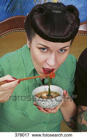 Picture - Young rockabilly woman eating <b>miso soup</b>. - 378017