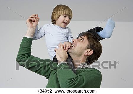 Stock Photo of A father and son rough housing 734052