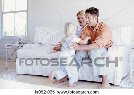 Stock Image - Parents playing with daughter . Fotosearch - Search Stock Photos, Mural Pictures, Photographs, and Photo Clipart