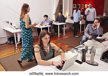 People At Work In Busy Modern Office Space People At Work In Busy Modern Office Space
