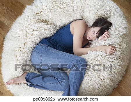Stock Image Of Woman On Furry Bean Bag Chair In Living Room Stock Image Of Woman On Furry Bean Bag Chair In Living Room