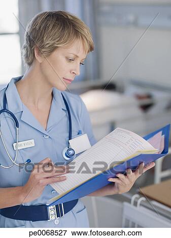 Picture of Nurse looking at patients medical chart 