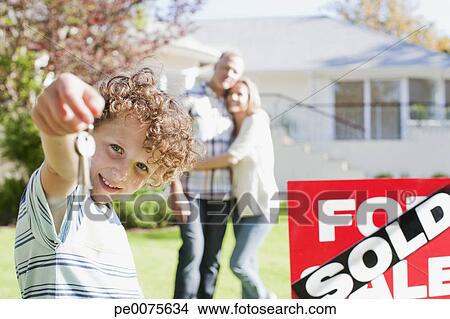 Stock Photo Of Boy Holding New House Keys Next To Sold Sign Stock Photo Of Boy Holding New House Keys Next To Sold Sign