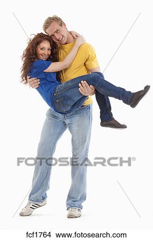 Man carrying woman in his arms Stock Photo, Royalty Free 