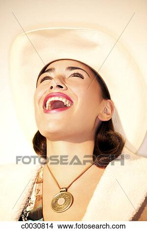 Stock Photo of Portrait of a cowgirl laughing with her head thrown back