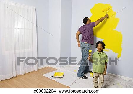 Stock Photo Of Man Painting Wall With Child Holding Up Paintbrush Stock Photo Of Man Painting Wall With Child Holding Up Paintbrush