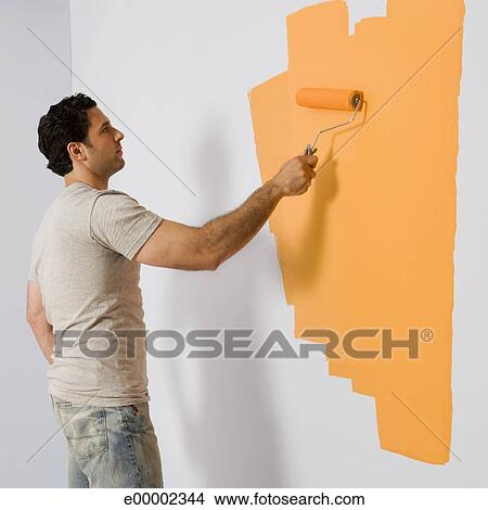 Stock Photo Of Man Painting Wall With Roller E00002344 Stock Photo Of Man Painting Wall With Roller E00002344