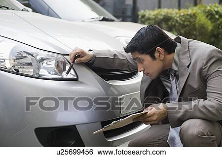Stock Images of Insurance adjuster inspecting a car u25699456 - Search Stock Photography, Poster