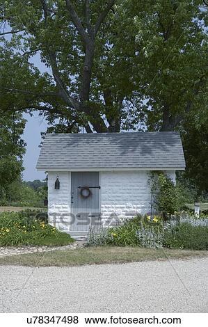 shed, small white painted concrete block building with grey roof 