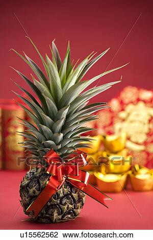 Stock Photo of Pineapple with ribbon, Chinese new year decoration in