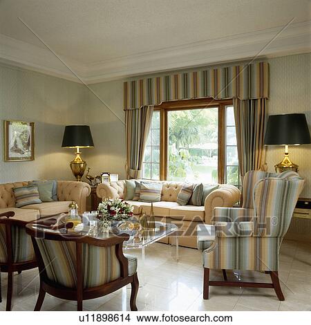 Traditional Living Room Curtains stock photo of neutral striped armchairs and curtains in Traditional Living Room Curtains stock photo of neutral striped armchairs and curtains in