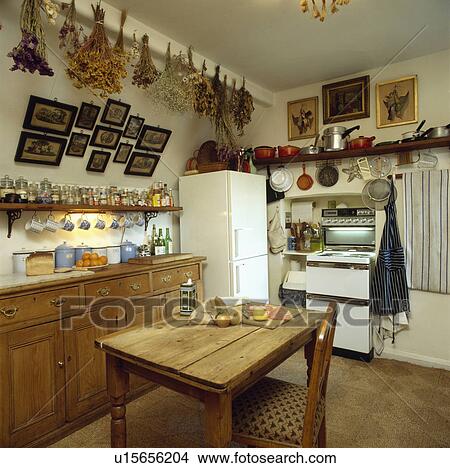 Old Fashioned Kitchen stock photo of pine table and chair in old-fashioned kitchen with Old Fashioned Kitchen stock photo of pine table and chair in old-fashioned kitchen with