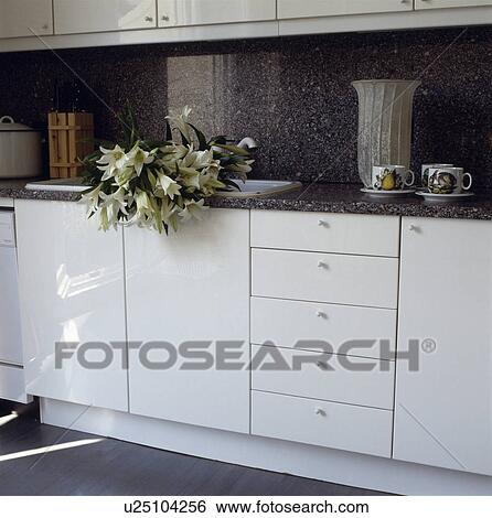 stock images of white lilies in sink in modern white kitchen with stock images of white lilies in sink in modern white kitchen with