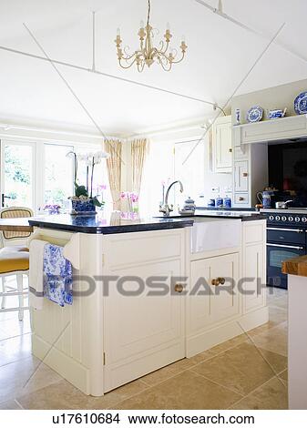stock photo of sink in cream island unit with black granite stock photo of sink in cream island unit with black granite