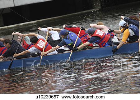 Picture of Team dragon boat racing. A method of team building used by 