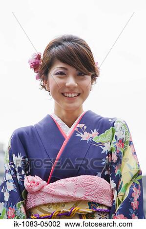 Stock Image - A Japanese young woman smiling. Fotosearch