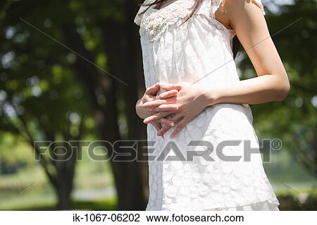 A woman in casual attire with fingers crossed View Large Photo Image Stock Image - A woman in casual attire with fingers crossed. Fotosearch
