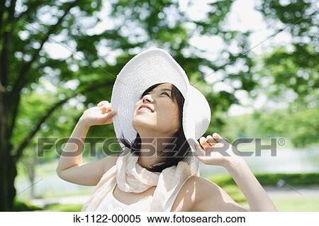 A young woman looking at sky View Large Photo Image Stock Photography - A young woman looking at sky. Fotosearch