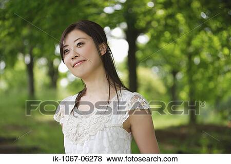 Stock Photo - A young woman smiling. Fotosearch