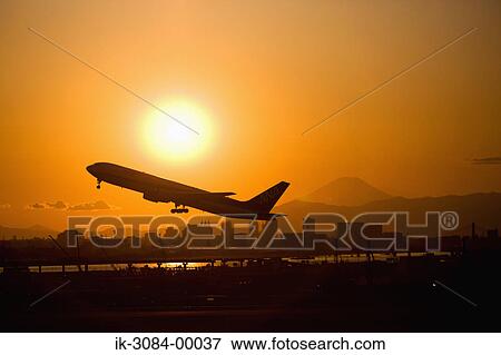 Aeroplane flying skywards at dusk View Large Photo Image Stock Photo - Aeroplane flying skywards at dusk. Fotosearch