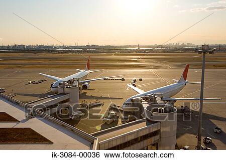 Stock Photograph - Airplanes parked in hangar at airport. Fotosearch