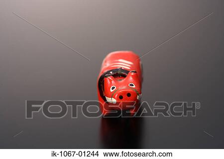 Picture - 'Akabeko' cow figurine. Fotosearch