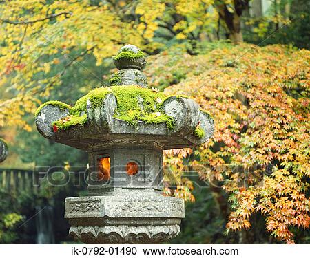 Stock Image - Ancient Stone Lantern Covered with Green Moss. Fotosearch