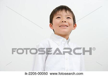 Stock Image - Asian boy smiling and looking up. Fotosearch