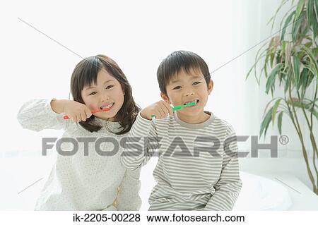 Asian brother and sister brushing together View Large Photo Image Stock Photo - Asian brother and sister brushing together. Fotosearch