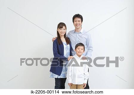 Picture - Asian couple standing with son. Fotosearch