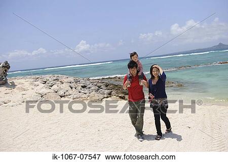 Stock Photo - Asian family Enjoying on beach. Fotosearch