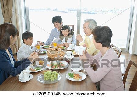 Asian family having breakfast together View Large Photo Image Stock Photograph - Asian family having breakfast together. Fotosearch