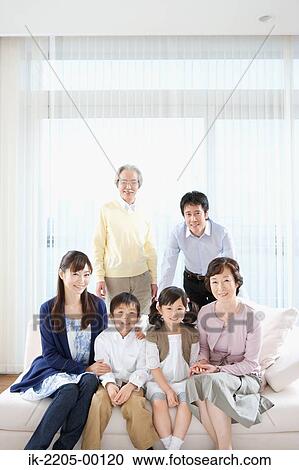 Stock Image - Asian family posing together and looking at camera. Fotosearch