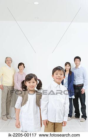 Asian family standing together in a v-shaped View Large Photo Image Stock Photo - Asian family standing together in a v-shaped. Fotosearch