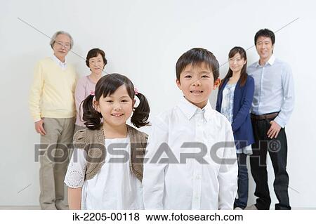 Stock Photo - Asian family standing together in a v-shaped. Fotosearch