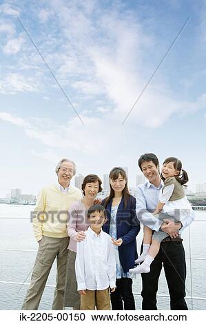 Stock Image - Asian family standing together. Fotosearch
