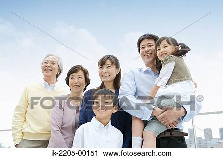 Stock Image - Asian family standing together. Fotosearch