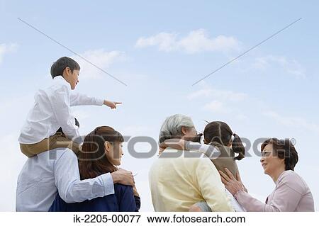 Asian family standing together View Large Photo Image Stock Photo - Asian family standing together. Fotosearch