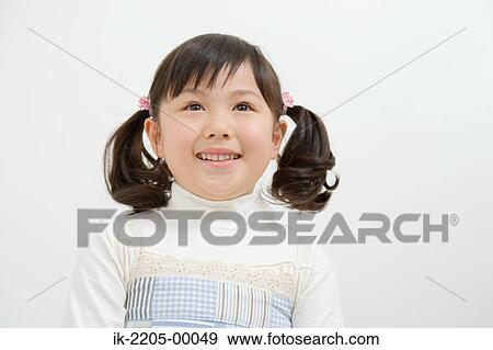 Asian girl smiling and looking up View Large Photo Image Stock Photo - Asian girl smiling and looking up. Fotosearch