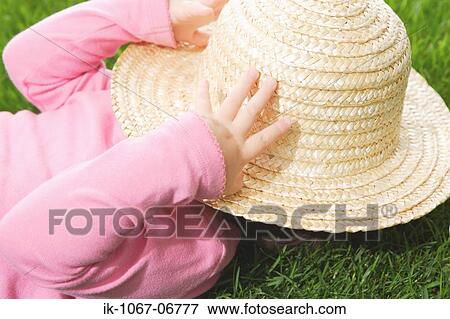 Baby face covered by sun hat View Large Photo Image Stock Photo - Baby face covered by sun hat. Fotosearch