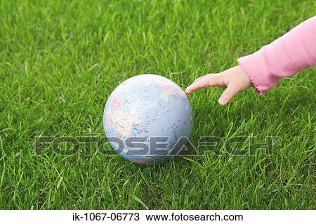 Baby hand reaching globe View Large Photo Image Stock Image - Baby hand reaching globe. Fotosearch